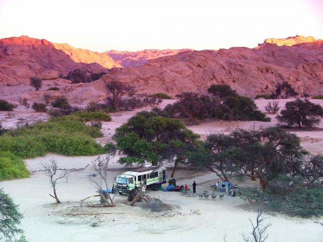 A beautiful evening at Spitzkoppe in Nambia unfolds, as an overland group unfolds their chairs.