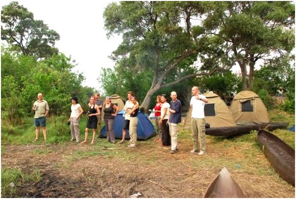 Overlanders leave dinner prep behind and scan the bush for game.